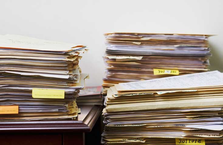 file record document search services stacked files against wall