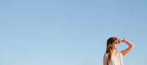 woman blue sky looking into distance
