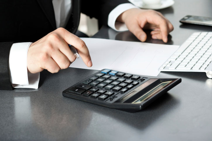 lender calculations at desk with calculator accurate rates